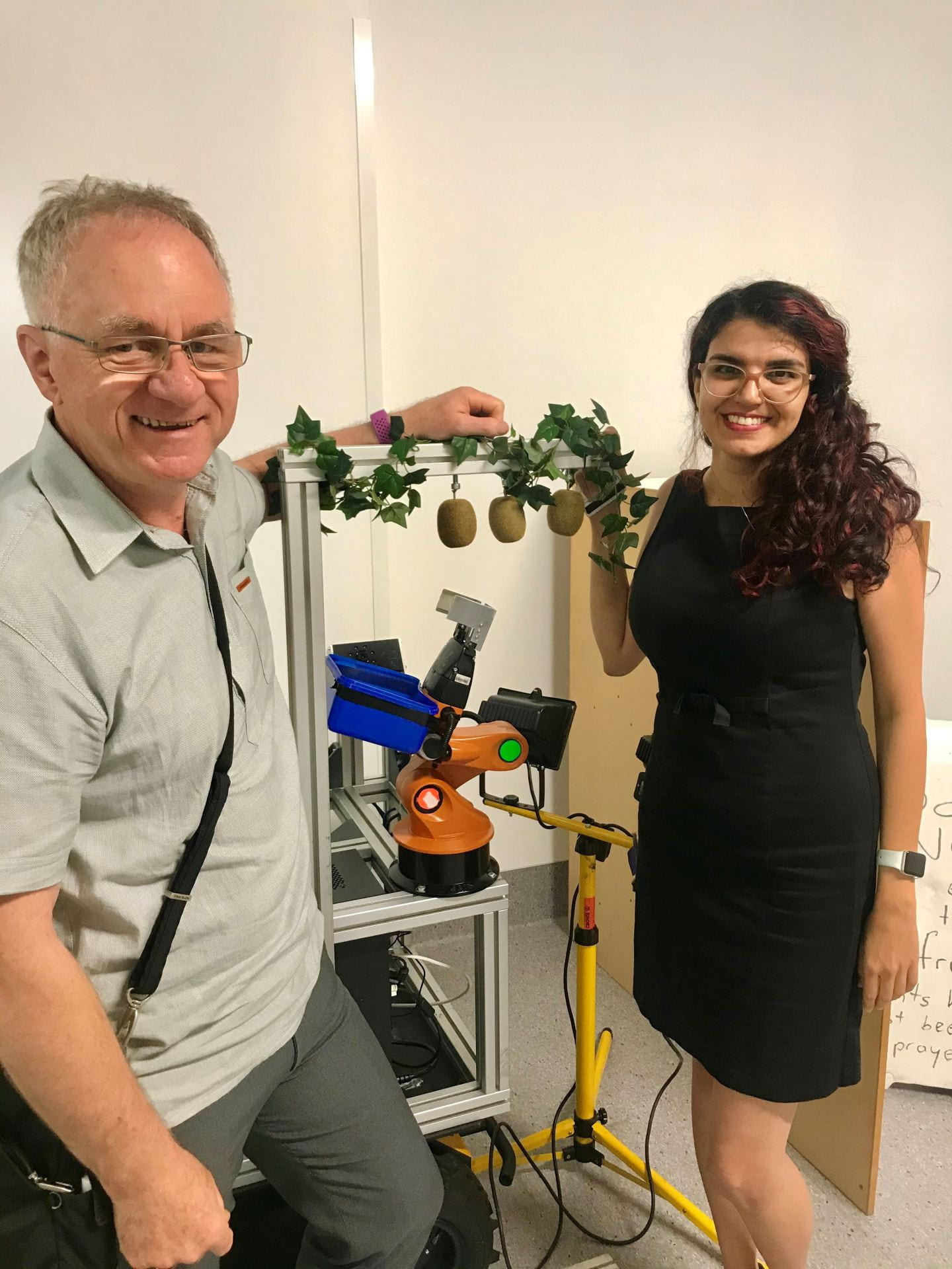 Prof Bruce MacDonald (left) and Dr Mahla Nejati (right) stand by a kiwifruit picking robot